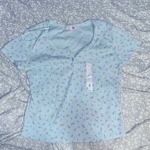 Blue, flower patterned shirt.